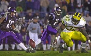 Nov. 4, 2000, Northwestern vs. Michigan: Anthony Thomas reaches for the ball that Sean Wieber (not pictured) poked loose. (photo from mlive.com)